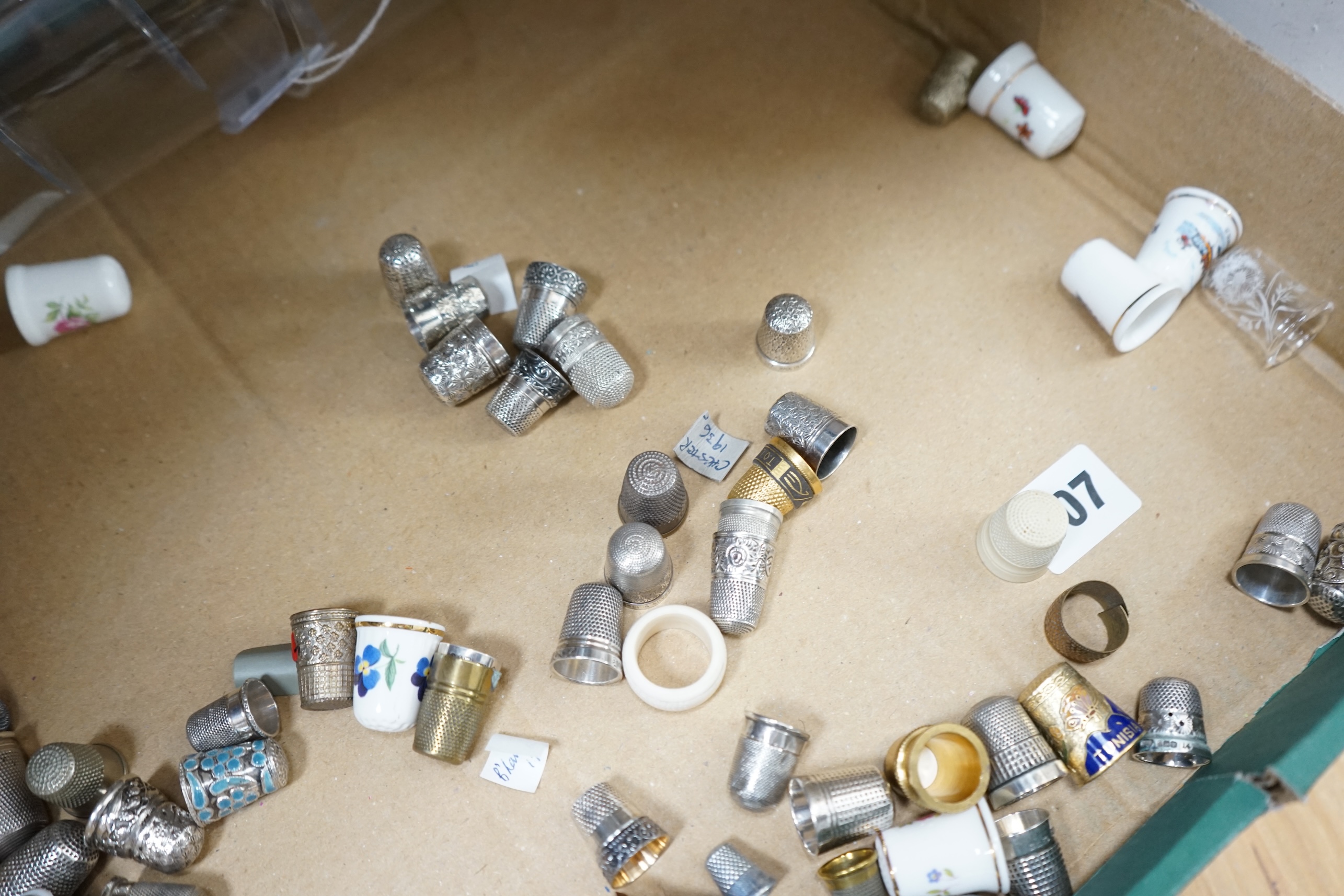 A large collection of silver, nickel, brass and ceramic thimbles, and two thimble display perspex domes. Condition - fair